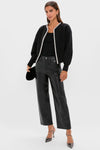 Black Sequin Trim Naomi Cardigan worn over a black tank, paired with high-waisted faux-leather pants and heels, creating a classic, effortless, high-end look.