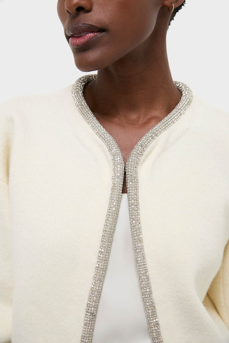 Model wearing the Ivory Sequin Trim Naomi Cardigan, featuring a classic and effortless design with sparkling trim, embodying Tuckernuck's fun and high-end style.