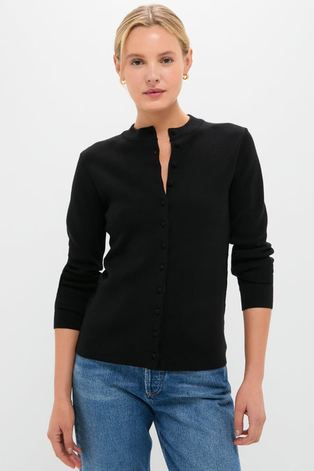 Person wearing the Black Viscose Margaux Cardigan, a classic and effortless high-end piece, showcasing a fun yet sophisticated style with its fitted design and long sleeves.
