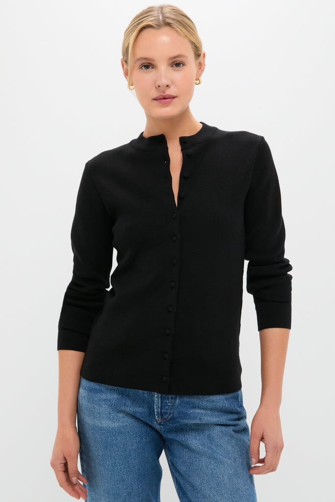 Person wearing the Black Viscose Margaux Cardigan, a classic and effortless high-end piece, showcasing a fun yet sophisticated style with its fitted design and long sleeves.