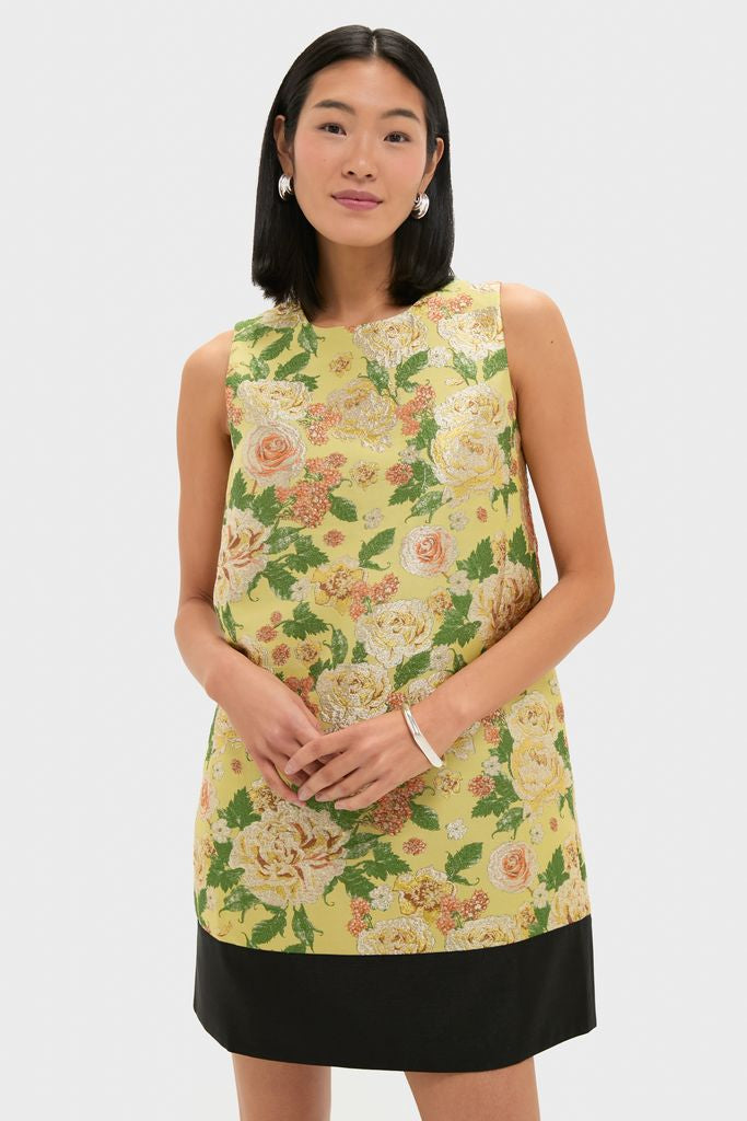 Chrysanthemum Jacquard Arcati Dress: A classic, high-end shift dress with an effortless floral jacquard print and contrast hem, modeled alongside silver accessories for a fun, chic look.
