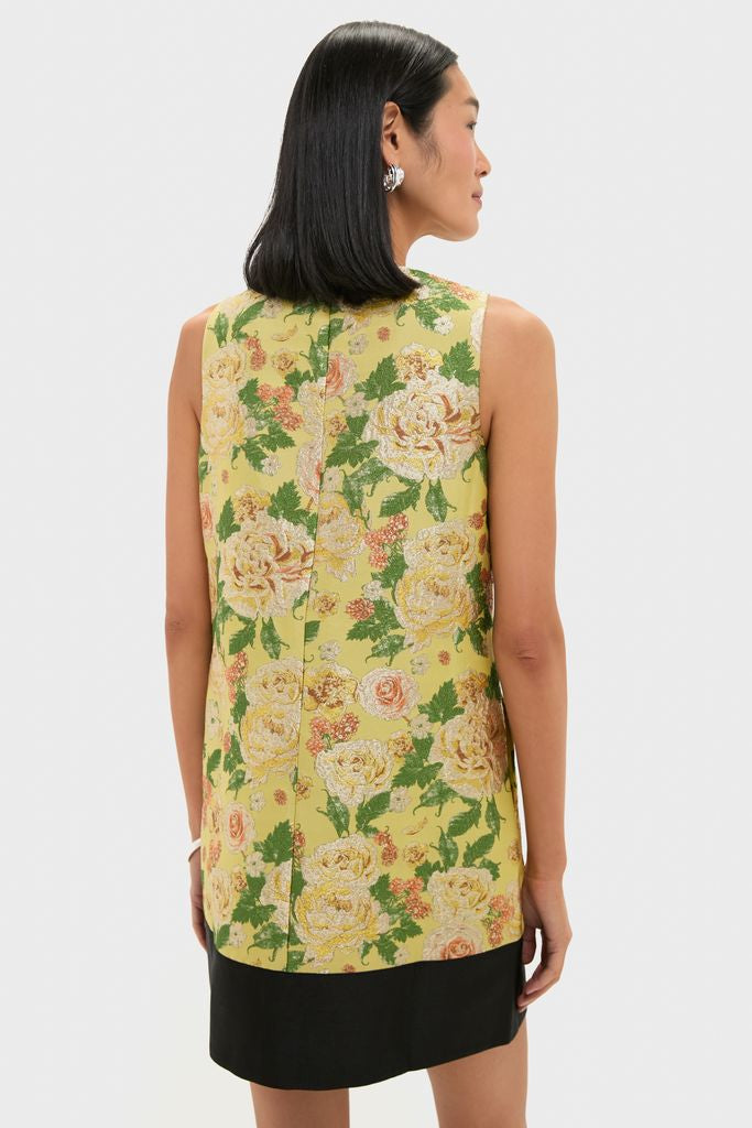 Model wearing the classic Chrysanthemum Jacquard Arcati Dress, showcasing an effortless shift silhouette in high-end floral jacquard, paired with sculptural silver earrings. Perfect for fun, stylish occasions.