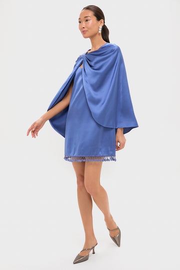 Model wearing the Blue Satin Mountbatten Cape with a fringed hem and draped shoulder, styled with statement earrings and heels; an effortless, high-end look perfect for festive occasions.