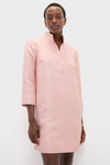 Woman models the classic Soft Pink Dupioni Megan Dress, featuring an effortless A-line silhouette, stand collar, and three-quarter sleeves, embodying a high-end, fun style.