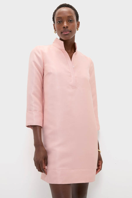 Woman models the classic Soft Pink Dupioni Megan Dress, featuring an effortless A-line silhouette, stand collar, and three-quarter sleeves, embodying a high-end, fun style.