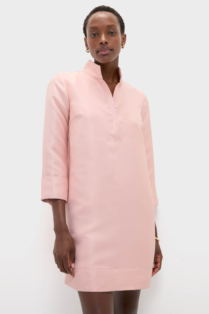Woman models the classic Soft Pink Dupioni Megan Dress, featuring an effortless A-line silhouette, stand collar, and three-quarter sleeves, embodying a high-end, fun style.