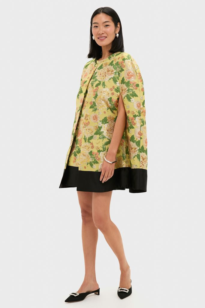 Model wearing the classic Chrysanthemum Jacquard Noel Cape, featuring an effortless cape-silhouette in floral jacquard, paired with pointed black mules and silver accessories, exuding a high-end, fun vibe.