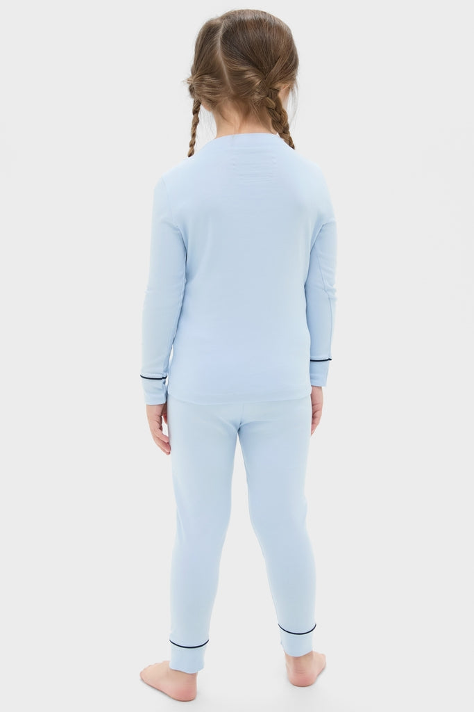 Child in a classic Light Blue Pima Cotton Arien Kid's Pajama Set with effortless mandarin collar and fun contrast trim, epitomizing high-end comfort and style.