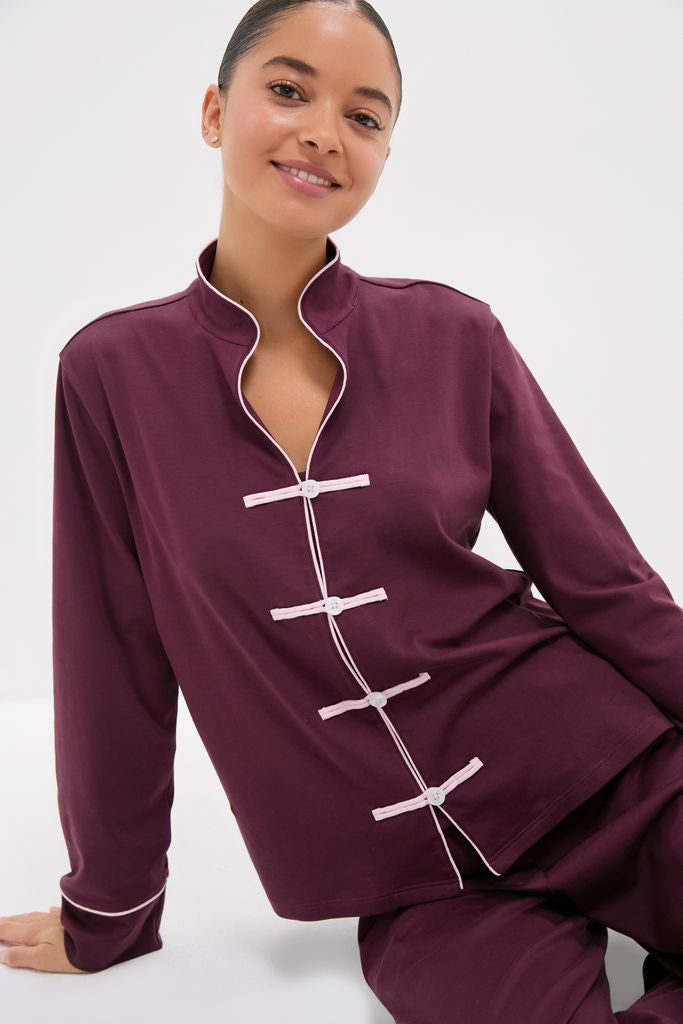 Young woman in a classic, high-end Winetasting Wilford Women's Pajama Set featuring effortless white piping and fun frog-style toggles, embodying relaxed sophistication.