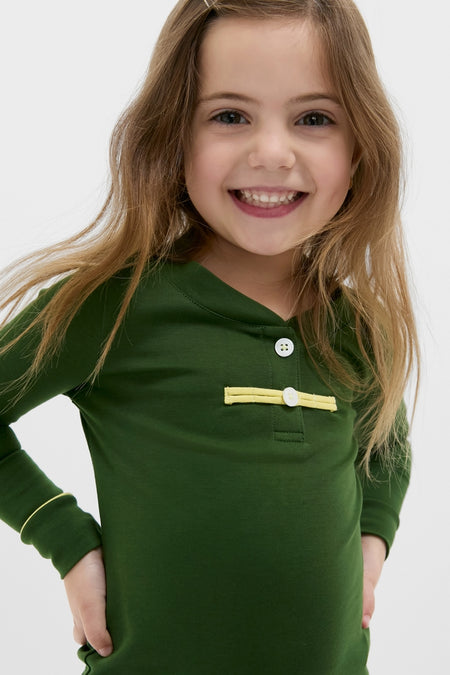 Young girl wearing the classic Douglas Fir Pima Cotton Arien Kid's Pajama Set, featuring a mandarin collar and contrast trim, embodies effortless, high-end comfort and fun.