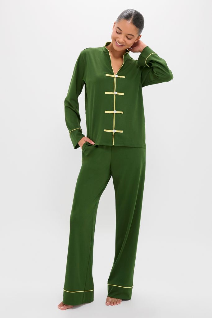 Model wearing the Green Wilford Women's Pajama Set, a classic, effortless lounge ensemble with East-inspired details and fun, high-end design elements like frog-style closures and yellow piping.