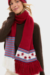 Person in dark sweater wears the USA Salt Lake Scarf, featuring classic stars, stripes, and tassel detailing, paired with a matching beanie for an effortless, high-end winter look.