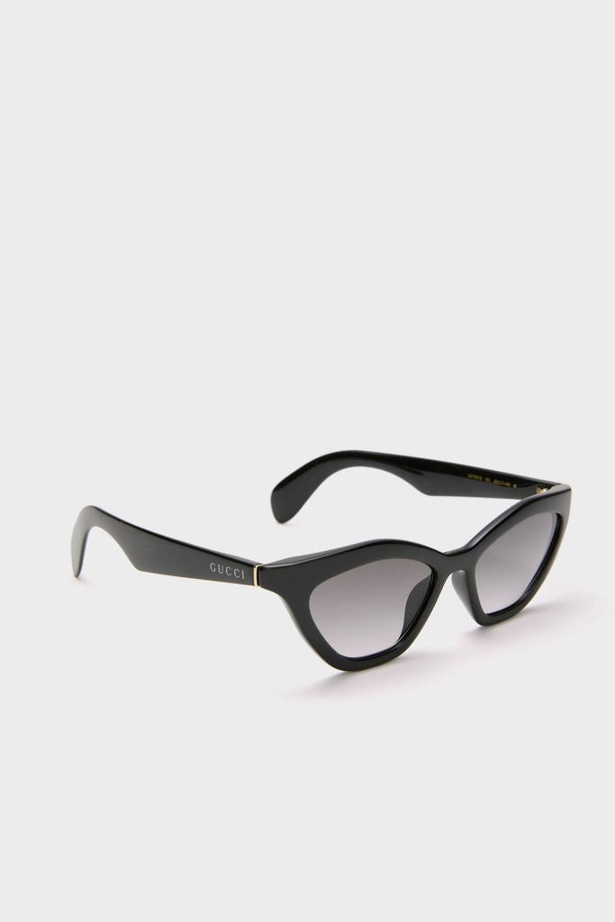 Shiny Black Cat-Eye Mods Sunglasses with glossy, winged frames and subtly tinted lenses, exuding a classic, effortless, and fun high-end style with the GUCCI logo on the arms.