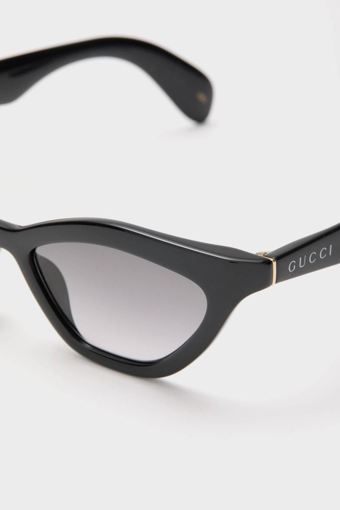 Shiny Black Cat-Eye Mods Sunglasses showcase classic, high-end style with an effortless fun twist, featuring Gucci-marked temples and gold accents for a confident look.