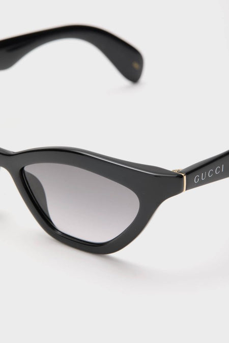 Shiny Black Cat-Eye Mods Sunglasses showcase classic, high-end style with an effortless fun twist, featuring Gucci-marked temples and gold accents for a confident look.