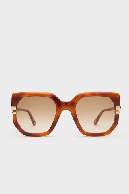 Shiny Blonde Havana West Sunglasses feature oversized geometric-square frames in tortoiseshell-brown with a classic, effortless style, soft brown gradient lenses, and fun metallic accents.