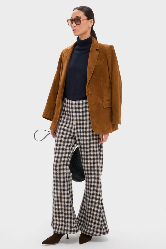 Model wearing classic, high-end Shiny Blonde Havana West Sunglasses with oversized square frames, adding an effortless, fun touch to her polished, retro-inspired autumn ensemble.