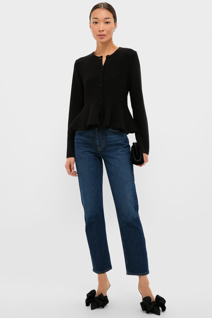 Model wearing the classic Black Knit Richmond Sweater, featuring a peplum design and three buttons, paired with effortless denim jeans and high-end mule heels for a fun, chic look.