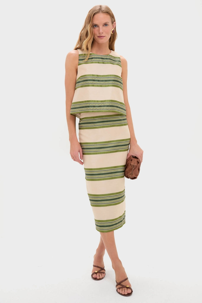 Woman models classic Satin Stripe Kerri Top in luxurious satin stripes, paired with a matching skirt, embodying an effortless, high-end, and fun style.