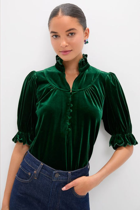 Hunter Green Velvet Selena Top features a classic high ruffled collar, puff sleeves, and covered buttons, paired with high-waisted jeans for an effortless, fun, high-end look.