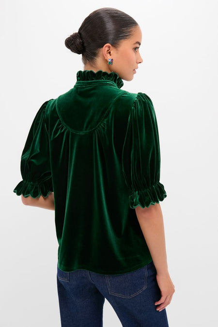 Hunter Green Velvet Selena Top with a ruffled collar and puff sleeves, styled with jeans, embodies a classic, effortless, and fun high-end look.