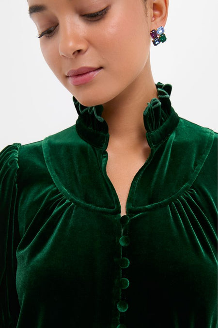 Person wearing the Hunter Green Velvet Selena Top with a ruffled collar and fabric-covered buttons, showcasing a classic, effortless, and high-end style.