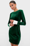 Model wearing the classic Hunter Green Velvet Etta Mini Dress with removable white cuffs, exuding an effortless, high-end style perfect for fun, festive gatherings.