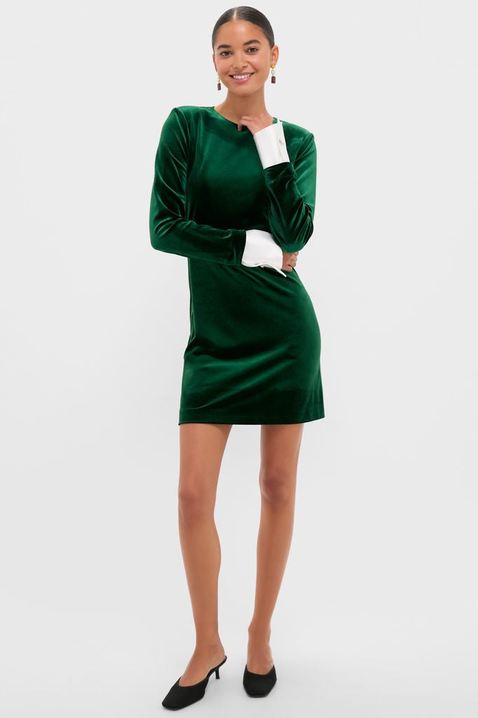 Model wears Hunter Green Velvet Etta Mini Dress with white cuffs, drop earrings, and black mules. A classic, high-end look perfect for effortless, fun occasions.