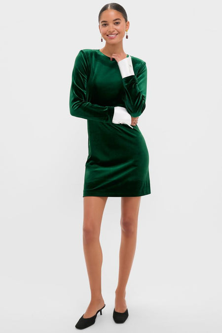 Model wears Hunter Green Velvet Etta Mini Dress with white cuffs, drop earrings, and black mules. A classic, high-end look perfect for effortless, fun occasions.