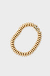 High Polish Gold Sofia Bracelet: A classic, high-end accessory with an effortless, fun vibe. Features ribbed, caterpillar construction, foldover closure, and JB-engraved clasp, embodying timeless elegance.