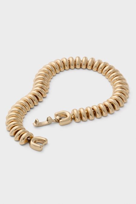 High Polish Gold Sofia Bracelet features classic, ribbed donut links in a fluid caterpillar design, offering an effortless and high-end touch to any ensemble.