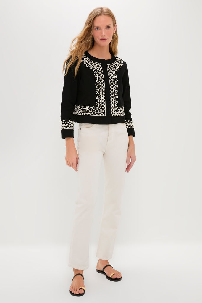 Woman wearing classic Soutache Cotton Maddy Jacket, featuring floral-inspired embroidery, paired with cream jeans and black sandals for an effortless, high-end look.