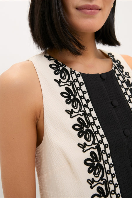 Soutache Cotton June Top: A classic, sleeveless piece featuring black and ivory panels with elegant embroidery and covered buttons, capturing a high-end, effortless style.
