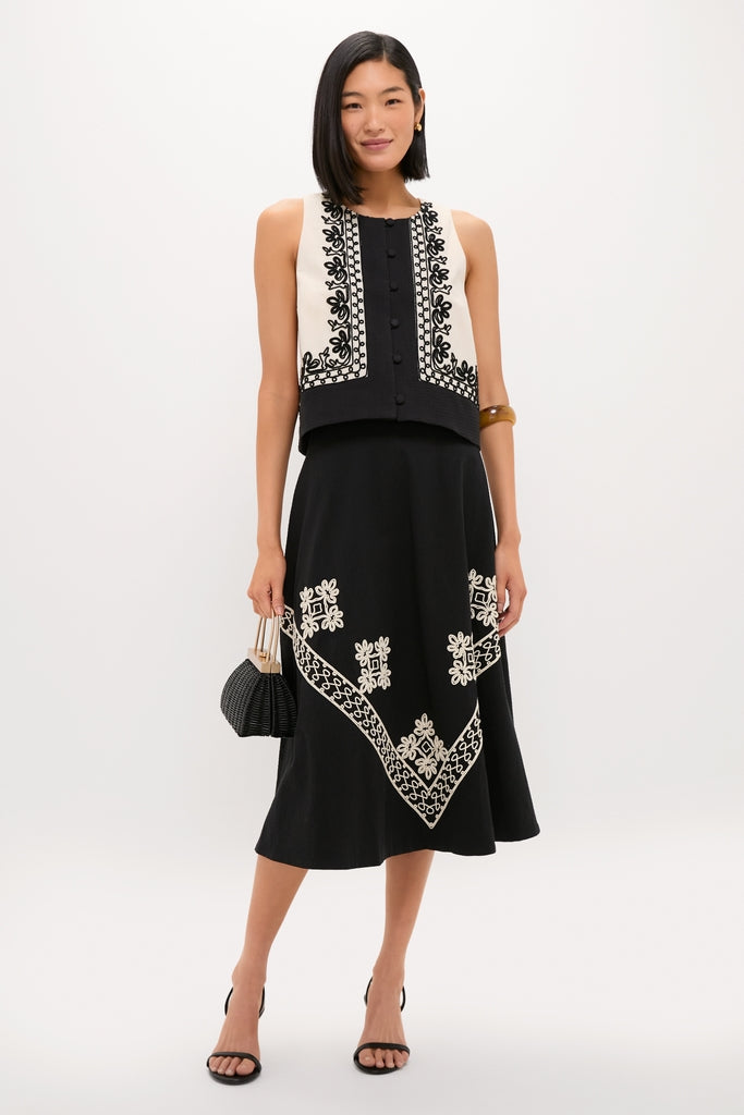 Model wearing the classic Soutache Cotton June Top with floral embroidery, paired with a midi skirt and high-end accessories for an effortless, fun look.