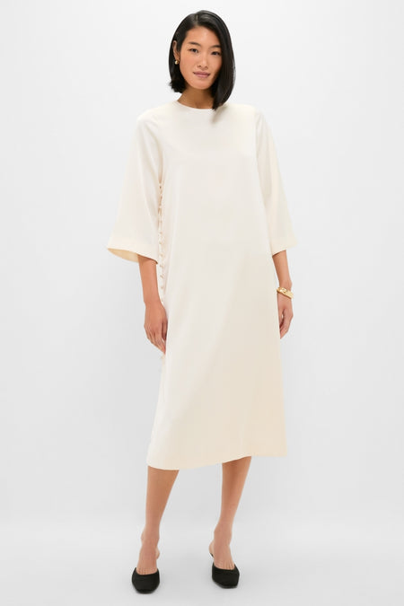Winter White Side Button Jamie Dress: A classic, effortless midi with elbow-length sleeves and side ties, paired with black pumps and gold jewelry for a fun, high-end look.