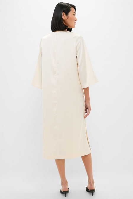 Winter White Side Button Jamie Dress exudes classic elegance with an effortless silhouette, fun side buttons, and elbow-length sleeves, perfect for high-end occasions.