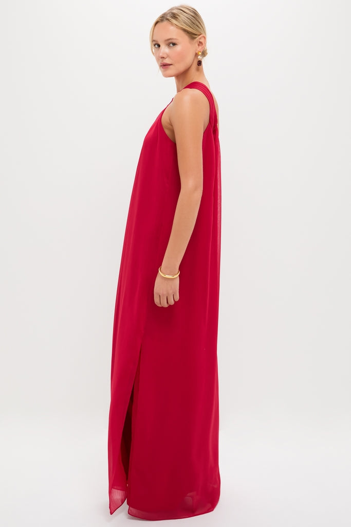 Young woman in profile wearing the Red Soleil Gown, a classic, sleeveless, floor-length dress with a side slit, embodying effortless elegance and high-end style.