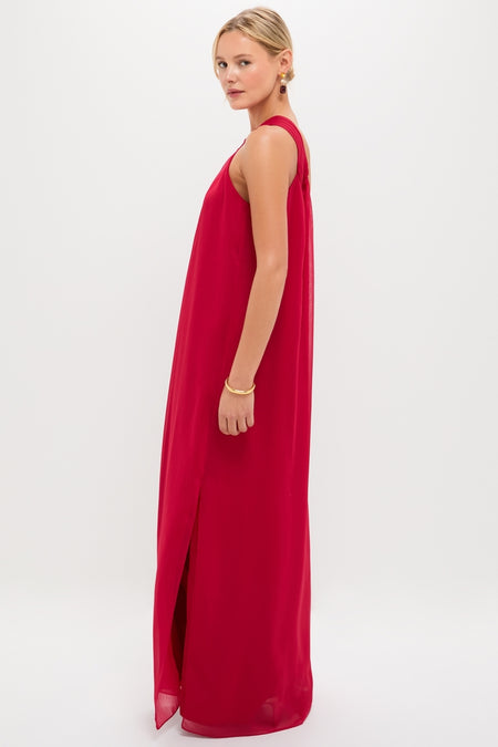 Young woman in profile wearing the Red Soleil Gown, a classic, sleeveless, floor-length dress with a side slit, embodying effortless elegance and high-end style.