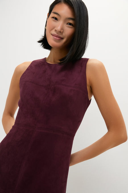 Woman in classic Winetasting Vegan Suede Manon Dress, a high-neck, sleeveless column silhouette with panel detailing, embodying effortless elegance and fun for cool weather occasions.