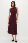 Winetasting Vegan Suede Manon Dress: A classic, effortless midi dress with a column silhouette and panel detailing, styled with gold jewelry and black flats for a fun, high-end look.