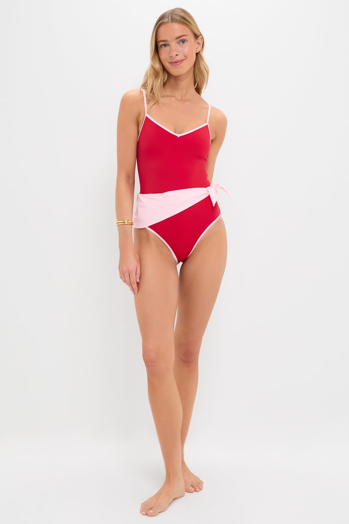 Young woman models the classic, high-end Poppy and Pink Cleo One Piece with Scarf, featuring an effortless wrap-style panel and fun pale-pink accents.