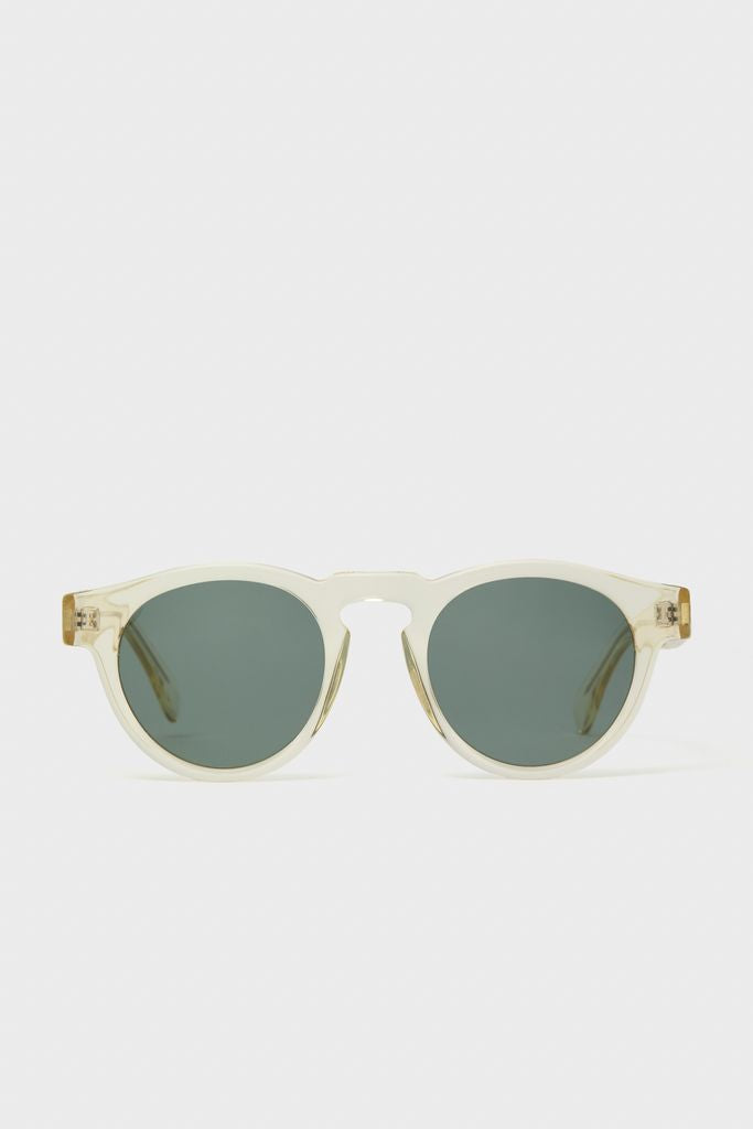 Champagne Leonard Sunglasses feature classic round green-tinted lenses, translucent frame, and keyhole bridge, offering an effortless, high-end look for everyday fun.