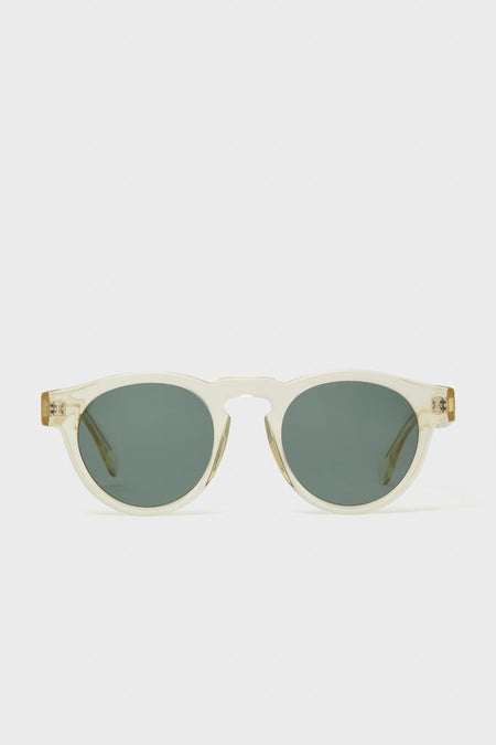 Champagne Leonard Sunglasses feature classic round green-tinted lenses, translucent frame, and keyhole bridge, offering an effortless, high-end look for everyday fun.