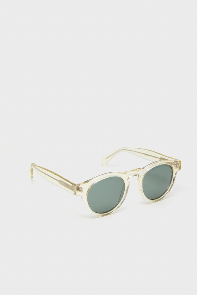 Champagne Leonard Sunglasses with round, dark-tinted lenses in a translucent frame, offering a classic, effortless style for high-end, fun everyday wear.