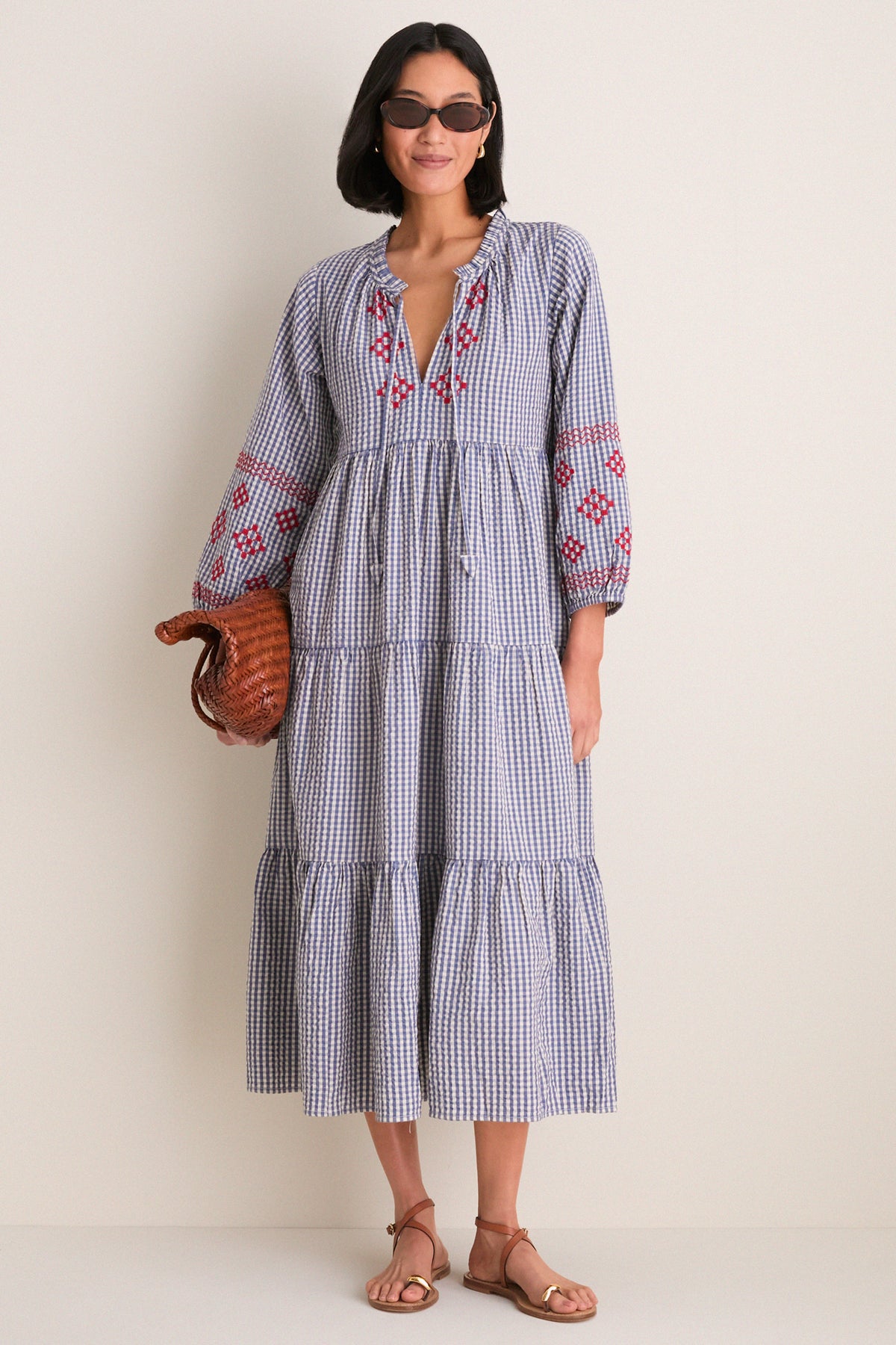 Woman wearing the Navy Prism Embroidered Gingham Long Sleeve Salty Paloma Caftan, showcasing a classic, effortless style with fun, high-end details.