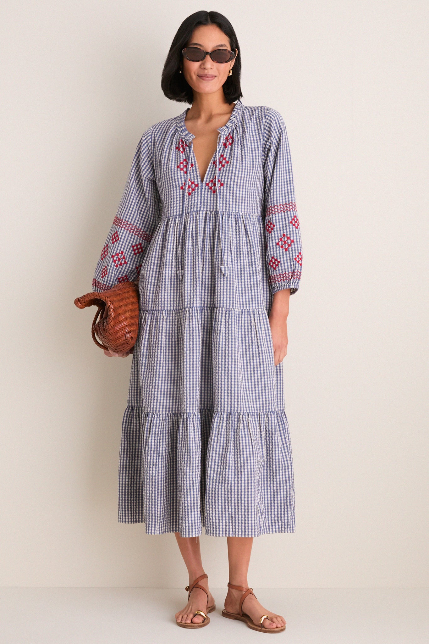 Woman wearing the Navy Prism Embroidered Gingham Long Sleeve Salty Paloma Caftan, showcasing a classic, effortless style with fun, high-end details.
