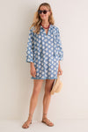 Young woman in a classic, effortless Bloom Lagoon Bondi Coverup, featuring a boho-chic style with floral design, tassel ties, and three-quarter sleeves, accessorized for fun, high-end casual elegance.