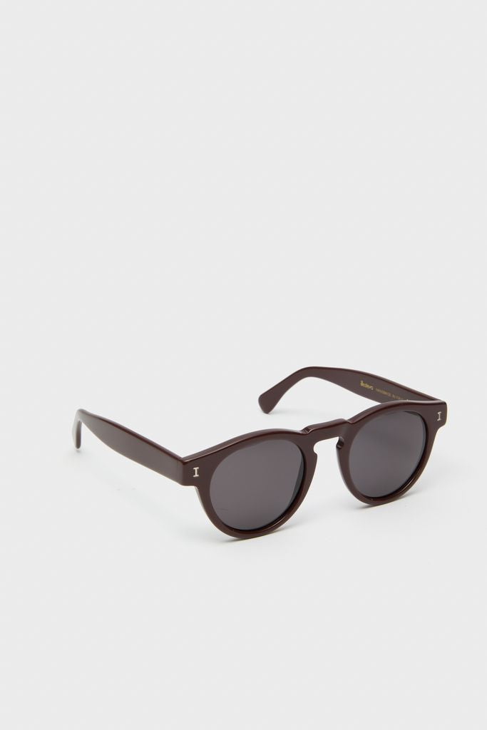 Bordeaux Leonard Sunglasses showcase classic, high-end design with round, dark-tinted lenses and effortless brown acetate frames, embodying Tuckernuck's fun and stylish shopping experience.