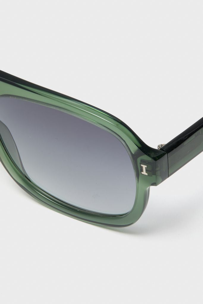 Pine Memphis Sunglasses with a classic aviator silhouette, featuring translucent green frames, dark gradient lenses, and metallic hinge details for an effortless, high-end look.