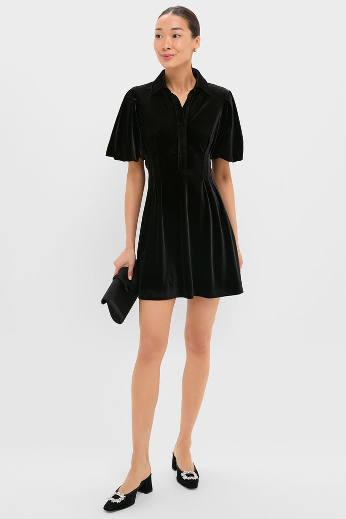 Black Velvet Mini Delaney Dress embodies classic elegance with a shirt-style collar, puffed sleeves, and fitted waist. Effortlessly chic, it's perfect for fun, high-end occasions.